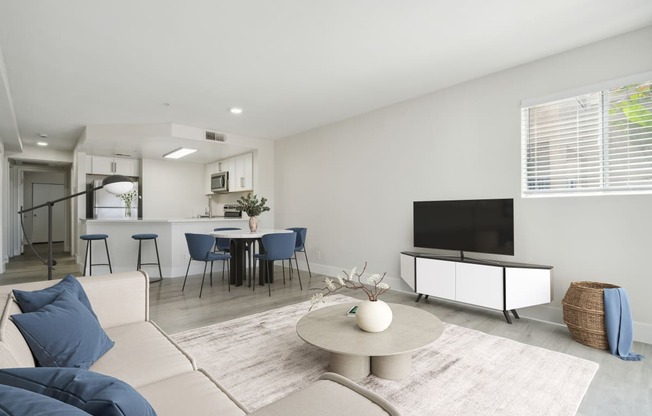 a living room with white walls and a white couch