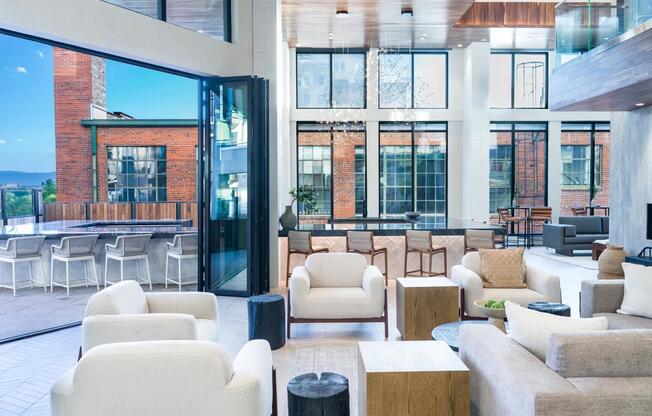 Experience the best of both worlds in our indoor/outdoor clubroom at Modera Golden Triangle. It's the perfect stylish setting for connecting, relaxing, and making memories.