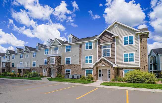 A large apartment building with a parking lot in front at Stoney Pointe Apartment Homes, Kansas, 67226