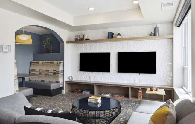 a rendering of a living room with two televisions and a coffee table