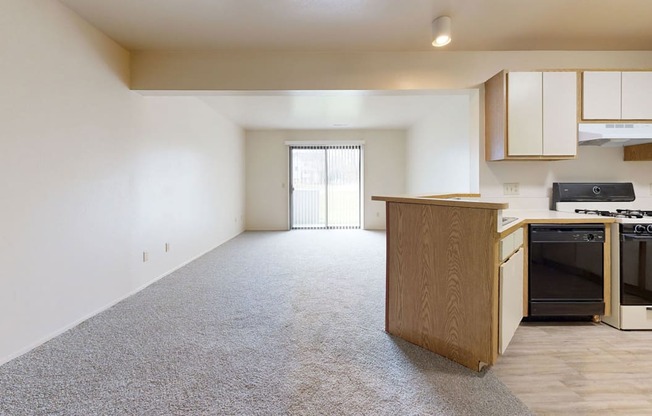 spacious living room and kitchen with a dishwasher