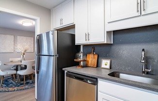 Renovated Kitchen with stainless steel appliances and quartz countertops at Elme Sandy Springs Apartments, Atlanta, GA