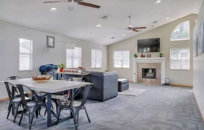 Common area with lounge area, fireplace and kitchen in the clubhouse at Skyline View apartments