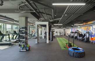 Woodland Hills, CA Apartments - The Q Variel - 7,000 Sq. Ft. State-Of-The-Art Wellness Center with Many Cardio and Strength Training Machines and Equipment, Functional Training Spaces, and Floor-to-Ceiling Windows