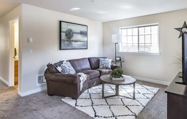 a living room with a couch and a coffee table  at Quail Springs, Washington