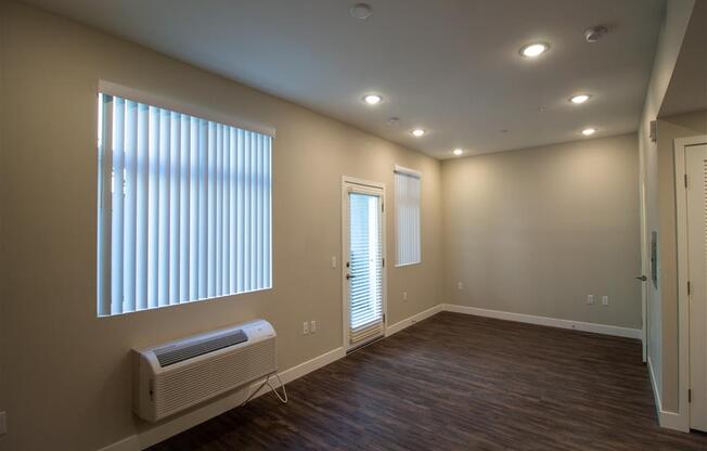 an empty room with a radiator and a large window at Loma Villas Apartments, California