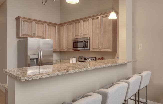 a kitchen with a granite counter top and stainless steel appliances