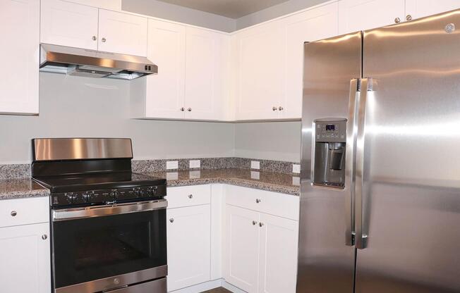 a stove top oven sitting inside of a kitchen