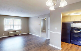 Kitchen with black appliances and open living room