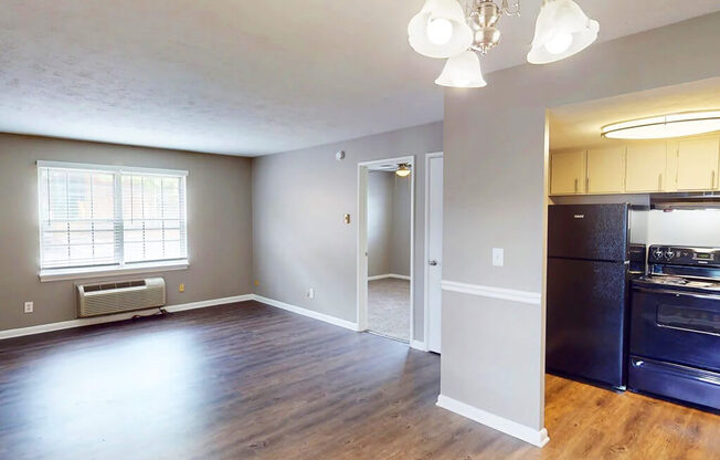 Kitchen with black appliances and open living room