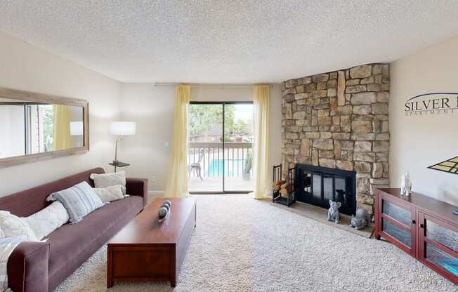 a living room with a large stone fireplace