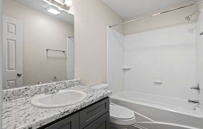 the preserve at ballantyne commons apartment bathroom with tub and sink and toilet at Diamond Ridge Townhomes, Oklahoma City