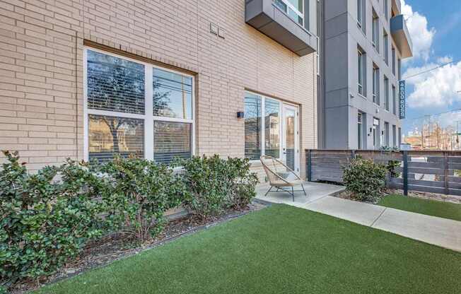 A building with a green lawn in front.