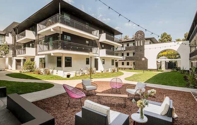 A modern building with a balcony and a clock tower.