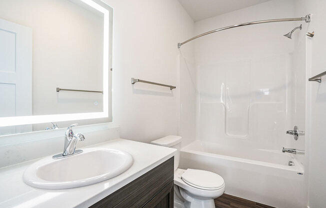 a bathroom with a sink toilet and bathtub at Meadowbrooke Apartment Homes, Grand Rapids, Michigan