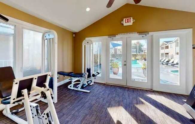 A weight training gym with a weight bench and gym equipment.