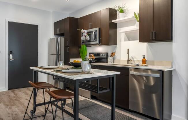 Model kitchen with an island and stainless steel appliances