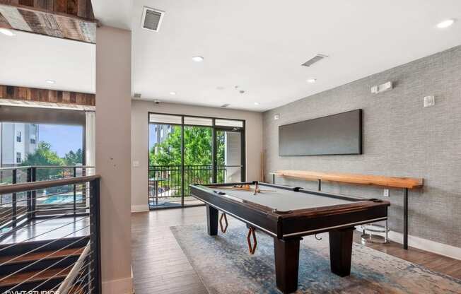 a game room with a pool table and a television