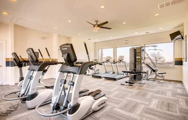 A gym with treadmills and elliptical machines at Mountain Vista Apartments, Lakewood, Colorado