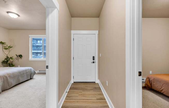 A white door is in the middle of a hallway.