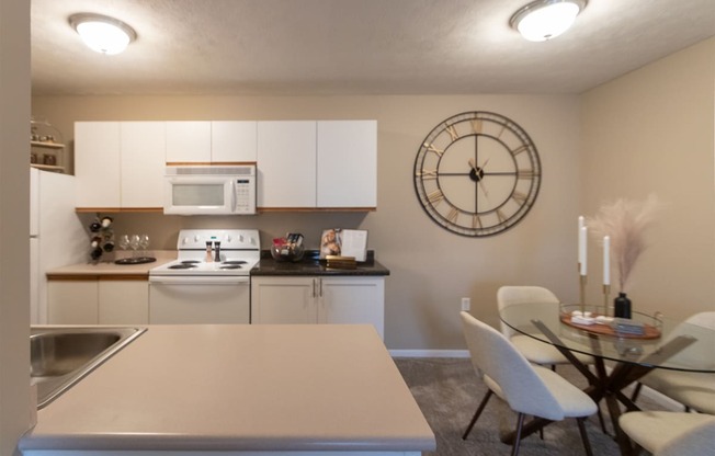 This is a photo of the kitchen and dining room of the 890 square foot 2 bedroom, 2 bath Liberty at Washington Place Apartments in in Miamisburg, Ohio in Washington Township.