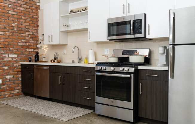 a kitchen with stainless steel appliances and white cabinets