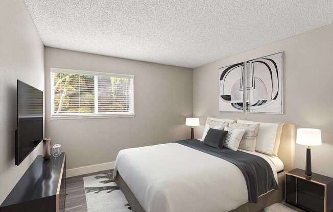 A bedroom with a large bed and a television on the wall.