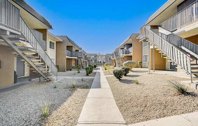 A row of houses with gravel in front of them.