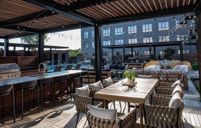 a patio with tables and chairs and a pool