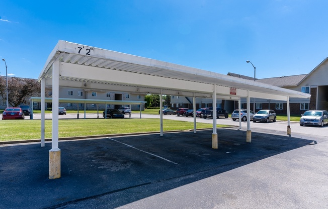 a parking lot with cars parked in front of a building
