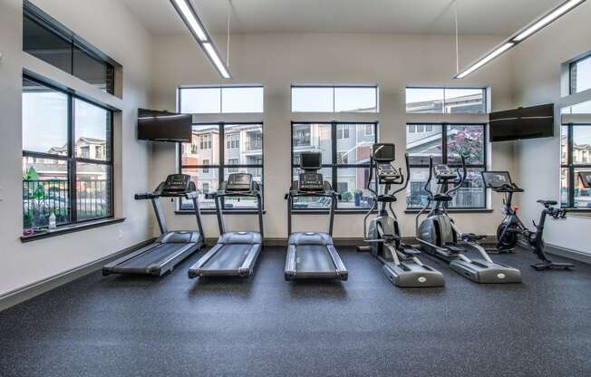 a gym with cardio equipment and windows at the briggs building