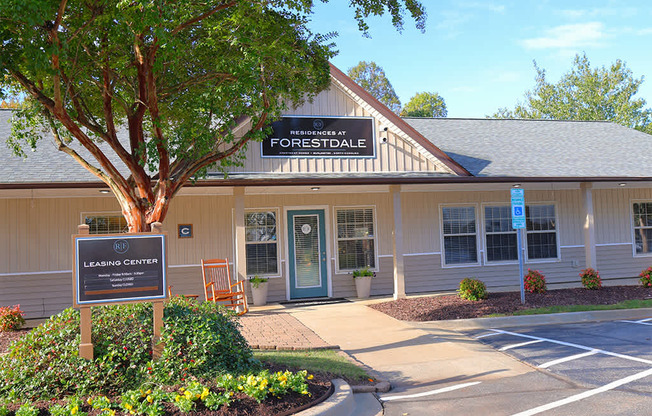 leasing office with a sign in front of it