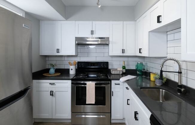 Apartments for Rent in Jacksonville, FL - Mandarin Bay Kitchen With Stainless Steel Appliances, White Cabinetry, and White Backsplash