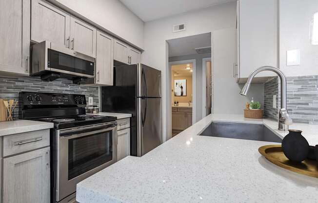 Apartments in Houston, TX for Rent – Gramercy Park - an updated kitchen with stainless steel appliances and white counter tops