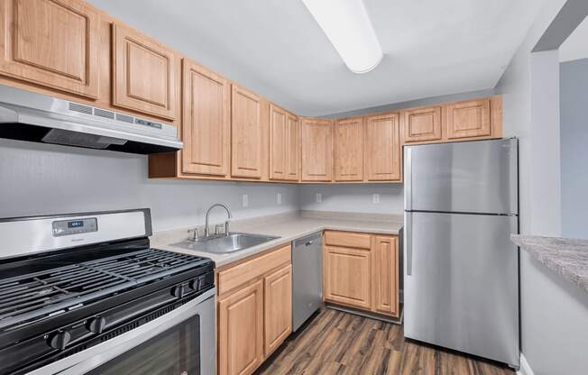 a kitchen with wooden cabinets and stainless steel appliances