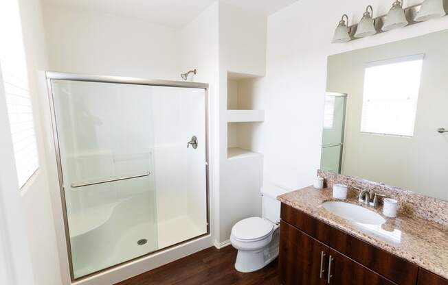 a bathroom with a shower and a sink and a toiletat The Vines at Riverpark, LLC, California, 93036