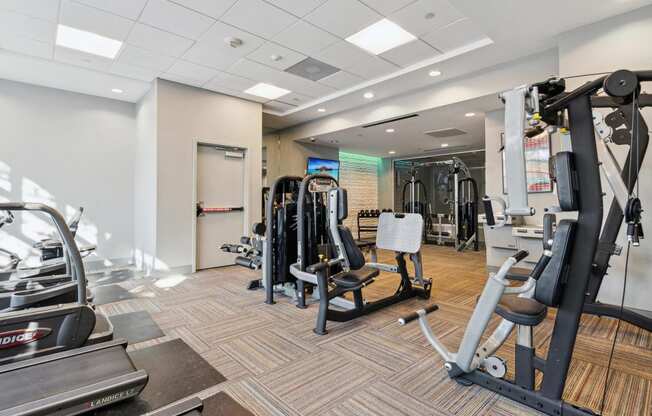 a gym with weights and cardio equipment in a building