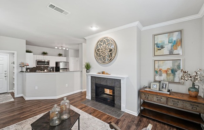 A living room with a fireplace and a large painting on the wall.