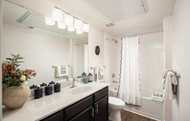 A bathroom with a white sink and a white toilet.