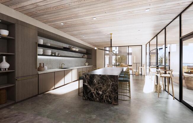 Kitchen with island seating and direct access to outdoor terrace.