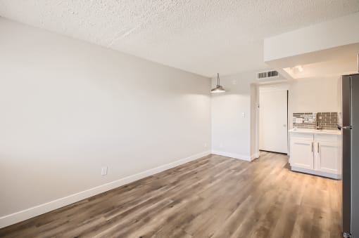 a bedroom with hardwood flooring at the oxford at estonia apartments in san an