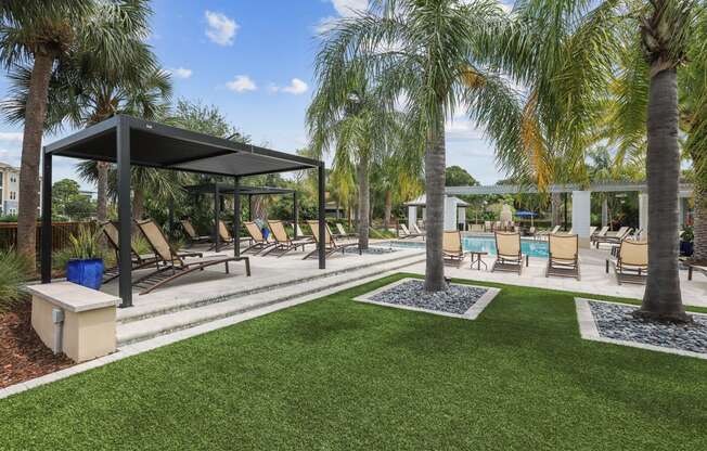 a lounge area with chairs and palm trees