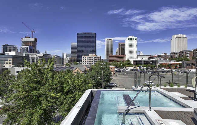 a city skyline with an infinity pool at Lotus Republic Apartments for rent in Downtown Salt Lake City, Utah