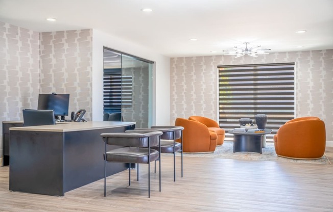 an office with a desk and chairs in front of a window