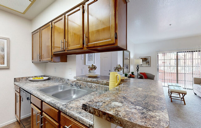 a kitchen with granite countertops and a living room with a couch