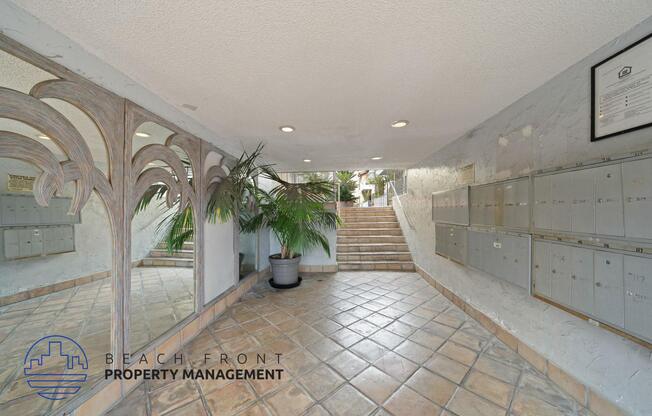 a view of the lobby of a building with tile floors and a staircase