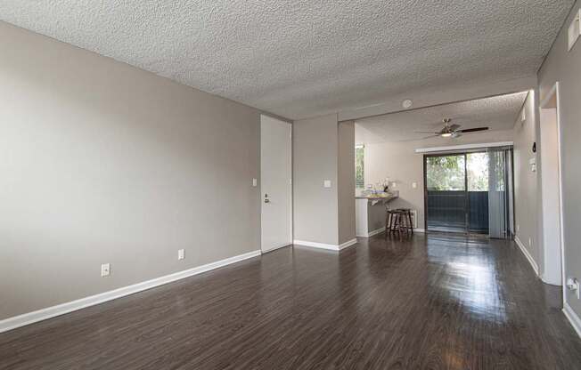 A room with wooden floors and a ceiling fan.