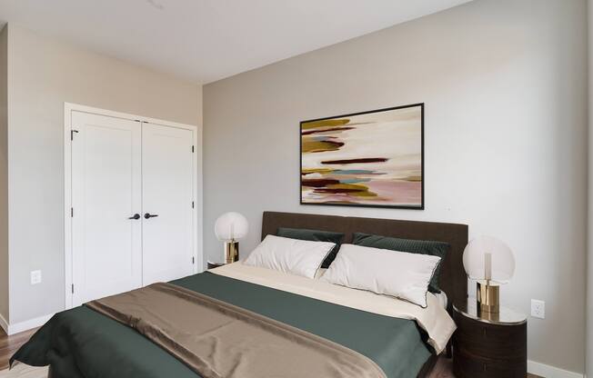 a bedroom with a large bed and two night stands with lamps