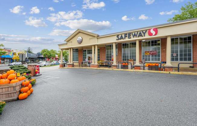 A Safeway store with a parking lot in front.