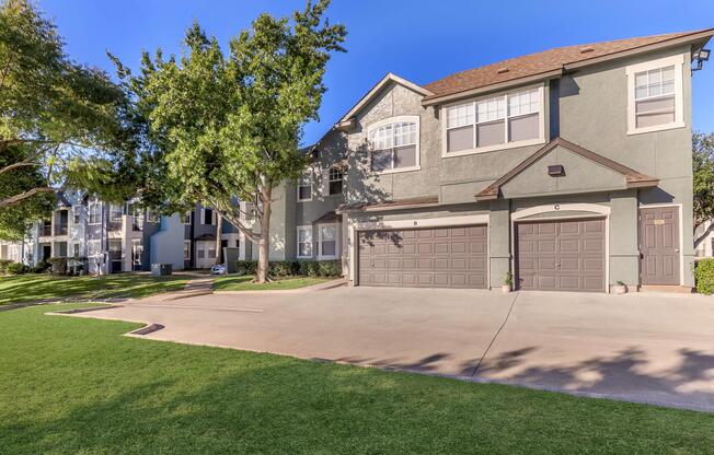 a house with a lawn in front of a building